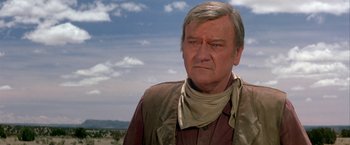 Movie still from “The Cowboys” (1972), directed by Mark Rydell – A person wearing a neck scarf; Close Up shot, Low angle