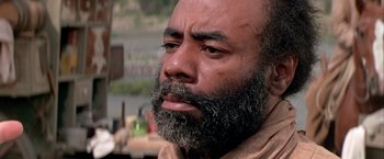 Movie still from “The Cowboys” (1972), directed by Mark Rydell – A person with a beard; Close Up shot, Low angle