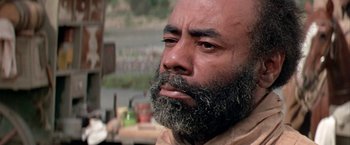 Movie still from “The Cowboys” (1972), directed by Mark Rydell – A person with a beard; Close Up shot, Low angle