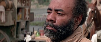 Movie still from “The Cowboys” (1972), directed by Mark Rydell – A bald man with a beard and a mustache; Close Up shot, Low angle