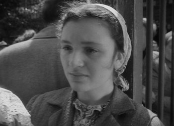 Movie still from “The Cranes Are Flying” (1957), directed by Mikhail Kalatozov – A young woman wearing a headscarf is looking at the camera; Close Up shot, High angle