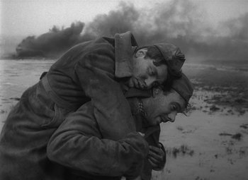 Movie still from “The Cranes Are Flying” (1957), directed by Mikhail Kalatozov – A couple of men hugging in the snow; Medium shot, High angle