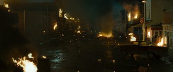 Movie still from “The Crazies” (2010), directed by Breck Eisner – A city street is lit up by a fire at night; Extreme Wide shot, High angle