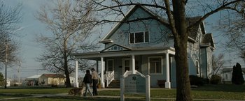 Movie still from “The Crazies” (2010), directed by Breck Eisner – Two people walking a dog in front of a house; Extreme Wide shot, Low angle