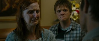 Movie still from “The Crazies” (2010), directed by Breck Eisner – A woman and a man sitting next to each other in a room; Close Up shot, Over the shoulder angle