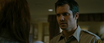 Movie still from “The Crazies” (2010), directed by Breck Eisner – A person wearing a shirt and tie; Close Up shot, Over the shoulder angle