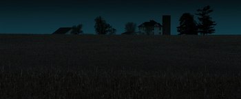 Movie still from “The Crazies” (2010), directed by Breck Eisner – A field that has a house in the background; Extreme Wide shot, Low angle
