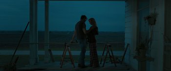 Movie still from “The Crazies” (2010), directed by Breck Eisner – A man and a woman standing next to each other; Wide shot, Over the shoulder angle