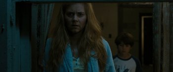 Movie still from “The Crazies” (2010), directed by Breck Eisner – A woman in a blue bathrobe looking at a mirror; Close Up shot, Over the shoulder angle