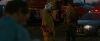Movie still from “The Crazies” (2010), directed by Breck Eisner – A man in a yellow jacket and a white helmet; Medium shot, Over the shoulder angle