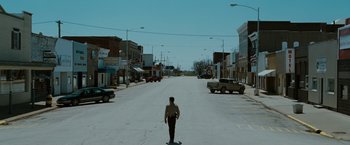 Movie still from “The Crazies” (2010), directed by Breck Eisner – A man standing in the middle of a street; Extreme Wide shot, High angle
