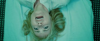 Movie still from “The Crazies” (2010), directed by Breck Eisner – A woman laying on the ground with her eyes open; Close Up shot, Overhead angle