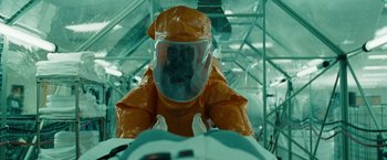 Movie still from “The Crazies” (2010), directed by Breck Eisner – A person in a hazmat suit in an industrial setting; Medium shot, Overhead angle