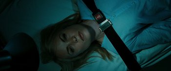 Movie still from “The Crazies” (2010), directed by Breck Eisner – A woman laying on the ground wearing a blue shirt; Close Up shot, Overhead angle