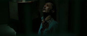 Movie still from “The Crazies” (2010), directed by Breck Eisner – A man in a blue shirt with blood on his face; Close Up shot, High angle