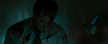 Movie still from “The Crazies” (2010), directed by Breck Eisner – A man in a white dress shirt and tie with blood on his face; Close Up shot, Low angle