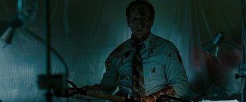 Movie still from “The Crazies” (2010), directed by Breck Eisner – A man in a tie holding a baseball bat; Medium shot, Low angle