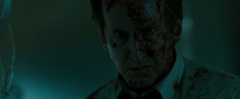 Movie still from “The Crazies” (2010), directed by Breck Eisner – A person wearing a suit and tie; Close Up shot, Low angle