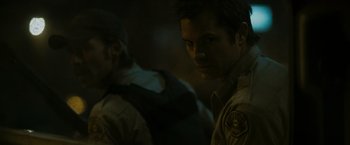 Movie still from “The Crazies” (2010), directed by Breck Eisner – A man in a police uniform looking at the camera; Close Up shot, Over the shoulder angle