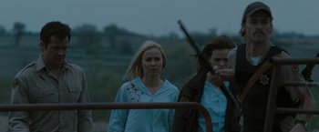 Movie still from “The Crazies” (2010), directed by Breck Eisner – Two women are walking in the rain holding a gun; Medium shot, Over the shoulder angle