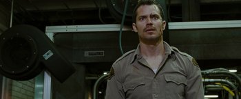 Movie still from “The Crazies” (2010), directed by Breck Eisner – A man wearing a uniform looking up at the sky; Close Up shot, Low angle