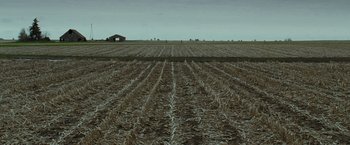 Movie still from “The Crazies” (2010), directed by Breck Eisner – An empty field with a barn in the distance; Extreme Wide shot, High angle