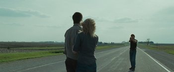 Movie still from “The Crazies” (2010), directed by Breck Eisner – A man and a woman walking down a road; Wide shot, Over the shoulder angle