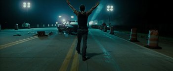 Movie still from “The Crazies” (2010), directed by Breck Eisner – A man walking down a street at night; Wide shot, Low angle