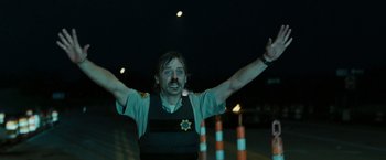 Movie still from “The Crazies” (2010), directed by Breck Eisner – A man in a police uniform with his mouth wide open; Medium shot, Low angle