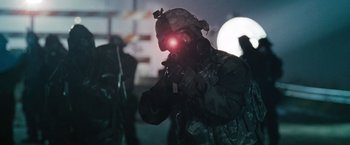 Movie still from “The Crazies” (2010), directed by Breck Eisner – A soldier wearing a night vision device; Medium shot, Low angle