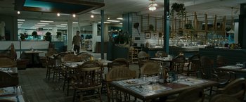 Movie still from “The Crazies” (2010), directed by Breck Eisner – People are sitting at tables in a restaurant; Wide shot, High angle