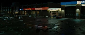 Movie still from “The Crazies” (2010), directed by Breck Eisner – A man standing in the middle of an empty parking lot at night; Extreme Wide shot, High angle