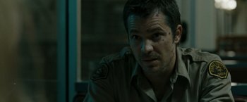 Movie still from “The Crazies” (2010), directed by Breck Eisner – A person wearing a uniform; Close Up shot, Over the shoulder angle