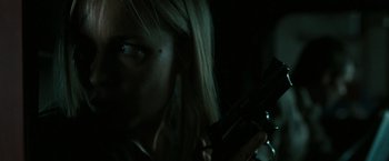 Movie still from “The Crazies” (2010), directed by Breck Eisner – A woman holding a gun in a dark room; Close Up shot, Low angle