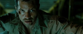 Movie still from “The Crazies” (2010), directed by Breck Eisner – A person wearing a shirt; Close Up shot, Over the shoulder angle