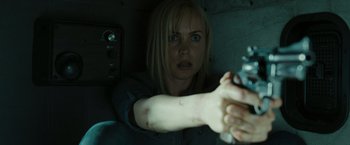 Movie still from “The Crazies” (2010), directed by Breck Eisner – A woman is holding a gun in a car window; Close Up shot, Over the shoulder angle