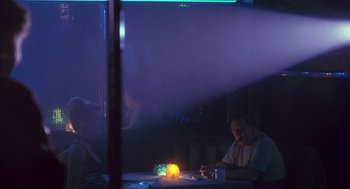 Movie still from “The Crossing Guard” (1995), directed by Sean Penn – Two people sitting at a table with a lit candle; Wide shot, Over the shoulder angle