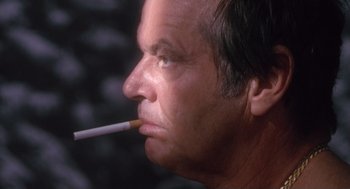 Movie still from “The Crossing Guard” (1995), directed by Sean Penn – A person with a cigarette in his mouth; Close Up shot, Low angle