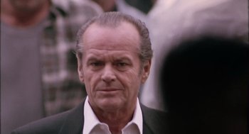 Movie still from “The Crossing Guard” (1995), directed by Sean Penn – An older man in a white shirt and black jacket; Close Up shot, Over the shoulder angle