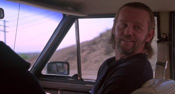 Movie still from “The Crossing Guard” (1995), directed by Sean Penn – A man sitting in the driver's seat of a car; Close Up shot, Over the shoulder angle