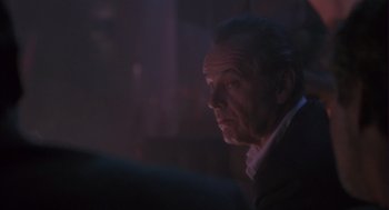 Movie still from “The Crossing Guard” (1995), directed by Sean Penn – An older man in a suit looking off into the distance; Close Up shot, Over the shoulder angle