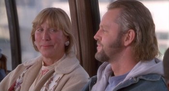 Movie still from “The Crossing Guard” (1995), directed by Sean Penn – A man and a woman sitting next to each other on a bus; Close Up shot, Over the shoulder angle