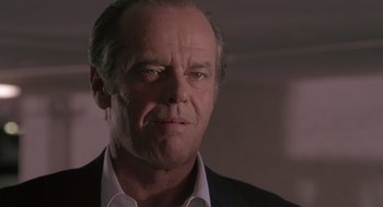 Movie still from “The Crossing Guard” (1995), directed by Sean Penn – A person wearing a suit and tie; Close Up shot, Low angle