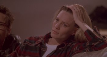 Movie still from “The Crossing Guard” (1995), directed by Sean Penn – A woman sitting down with her hand on her head; Close Up shot, High angle