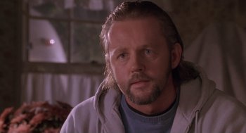 Movie still from “The Crossing Guard” (1995), directed by Sean Penn – A person with long hair and a beard; Close Up shot, Low angle