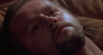 Movie still from “The Crossing Guard” (1995), directed by Sean Penn – A man's face as he lays in bed; Close Up shot, High angle