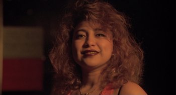 Movie still from “The Crossing Guard” (1995), directed by Sean Penn – A person with curly red hair; Close Up shot, Low angle