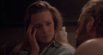 Movie still from “The Crossing Guard” (1995), directed by Sean Penn – A person holding their hand to her face; Close Up shot, Over the shoulder angle