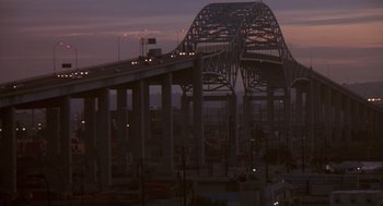 Movie still from “The Crossing Guard” (1995), directed by Sean Penn – A large bridge that has some cars on it; Extreme Wide shot, High angle
