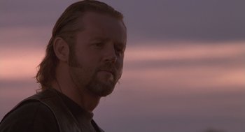 Movie still from “The Crossing Guard” (1995), directed by Sean Penn – A person with long hair; Close Up shot, Low angle